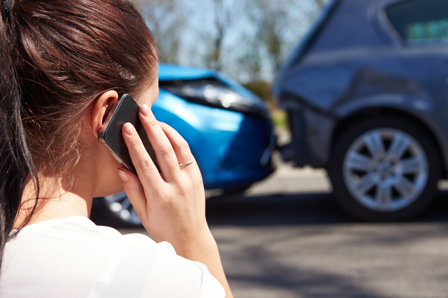 woman on phone after rear end accident